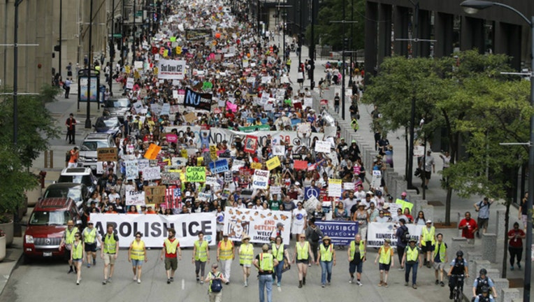 The protesters at Saturday's Chicago march belted chants critical of President Donald Trump and the Immigration and Customs Enforcement agency.