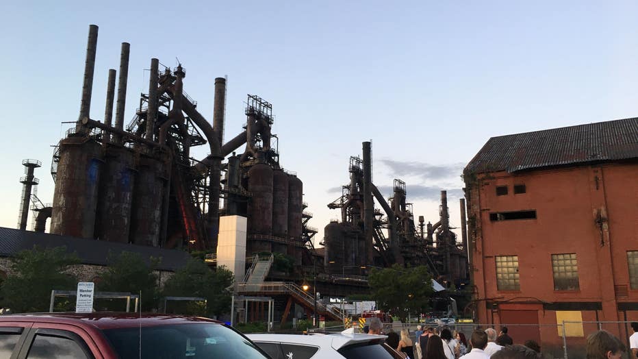 Authorities say a man climbed to the top of a former Bethlehem Steel Corp. blast furnace and refused to come down, prompting evacuation of the arts and entertainment venue at the eastern Pennsylvania site.