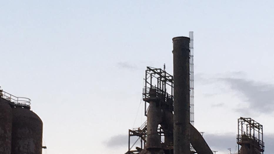 Authorities say a man climbed to the top of a former Bethlehem Steel Corp. blast furnace and refused to come down, prompting evacuation of the arts and entertainment venue at the eastern Pennsylvania site.