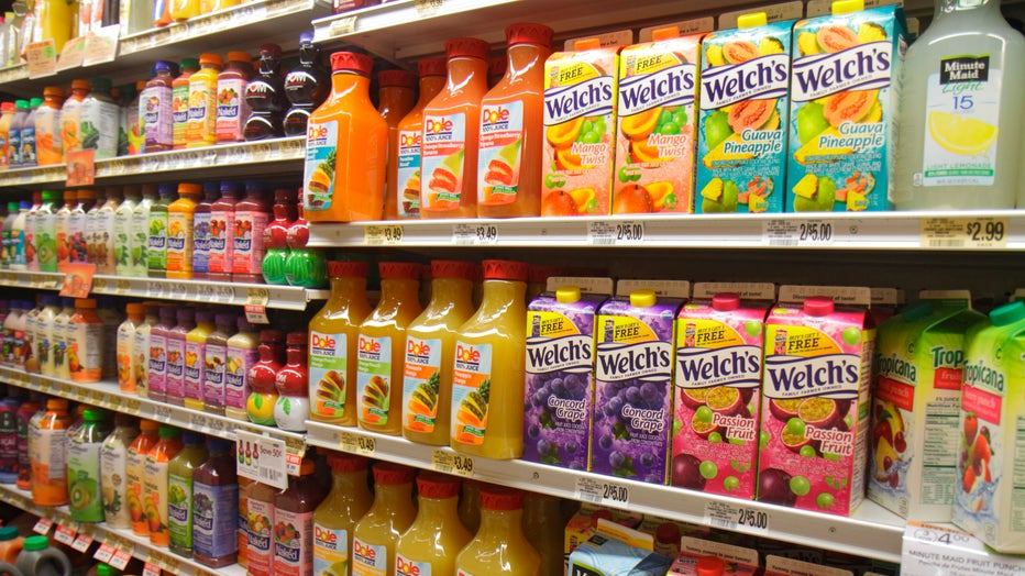 Shelves of fruit juices are shown in this file image at a grocery store. (Photo by: Jeffrey Greenberg/Universal Images Group via Getty Images)