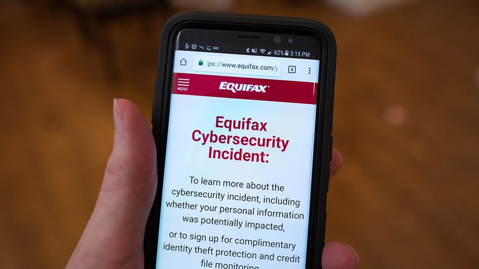 A mobile phone is held open to the Equifax website following the 2017 security breach that led to 147 million people's data being compromised.