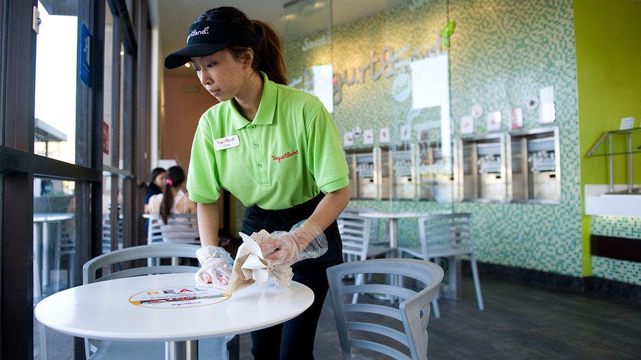 Vivian Pham, a community college student, works her summer job as an associate at Yogurtland. Vivian didn't get her first job until after graduating high school. Her mom, who waitressed during high school as a single mom, encouraged her to focus on her studies instead of working during high school.