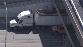 Tractor-trailer lodged underneath pedestrian bridge at PHL removed