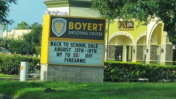 Gun store marquee advertises ‘back to school’ sale on firearms