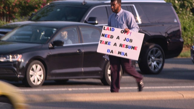 Laid off Charlotte father of 2 with MBA passing out resumes during rush hour