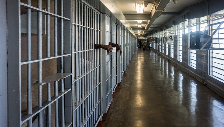 ANGOLA PRISON, LOUISIANA - OCTOBER 14, 2013: A prisoner's hands inside a punishment cell wing at Angola prison. The Louisiana State Penitentiary, also known as Angola, and nicknamed the 