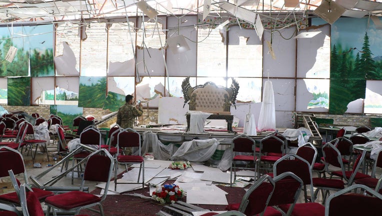 Afghan security officials inspect the scene after an overnight suicide bomb blast at a wedding reception in Kabul, Afghanistan on August 18, 2019.