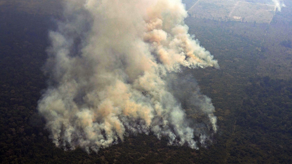 Aerial picture showing smoke from a two-kilometre-long stretch of fire billowing from the Amazon rainforest, in northern Brazil. 
