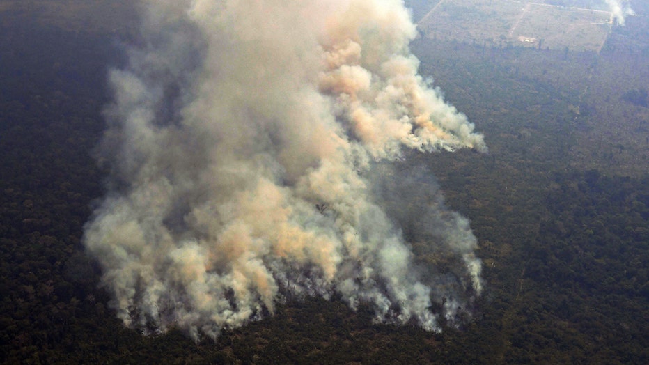 Aerial picture showing smoke from a two-kilometre-long stretch of fire billowing from the Amazon rainforest, in northern Brazil.