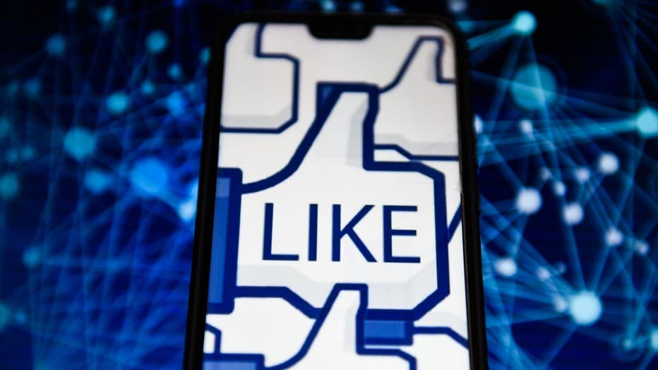 52fc25d9-The Facebook like logo is seen displayed on an Android mobile phone. The tech giant is experimenting with hiding likes in Australia.