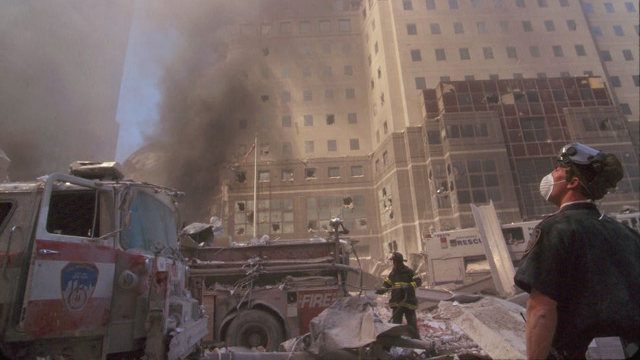 A first responder looks up during rescue efforts during the 9/11 terror attacks on the Twin Towers. Photograph is from 8 rolls of unedited film taken by an anonymous photojournalist at ground zero that day.