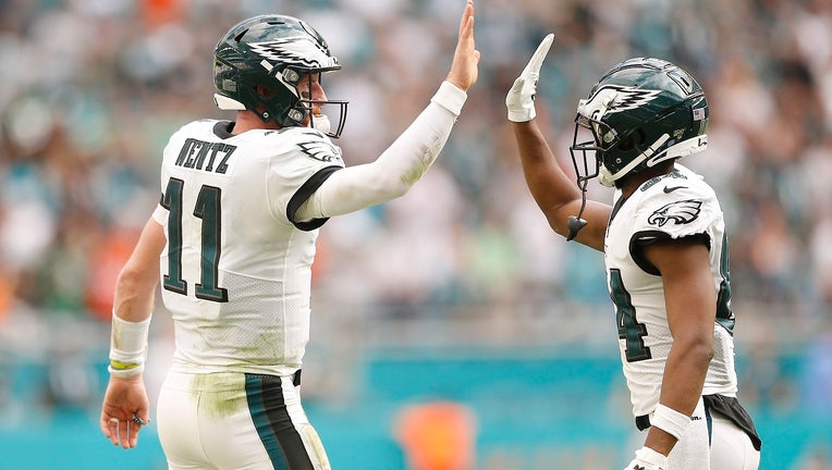 Carson Wentz high fives Greg Ward after a touchdown.