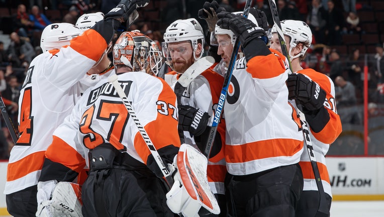 The Philadelphia Flyers celebrate a shootout win over Ottawa Senators.