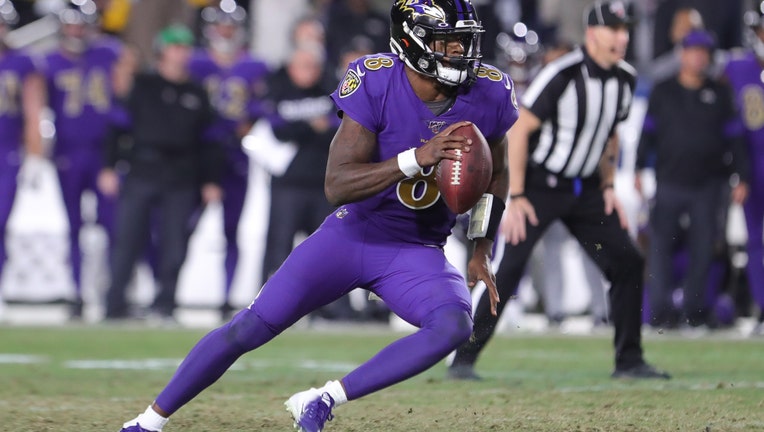 FILE - Quarterback Lamar Jackson #8 of the Baltimore Ravens carries the ball against the Los Angeles Rams at Los Angeles Memorial Coliseum on November 25, 2019 in Los Angeles, California.