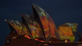 Sydney Opera House illuminates with faces of fire fighters battling wildfires