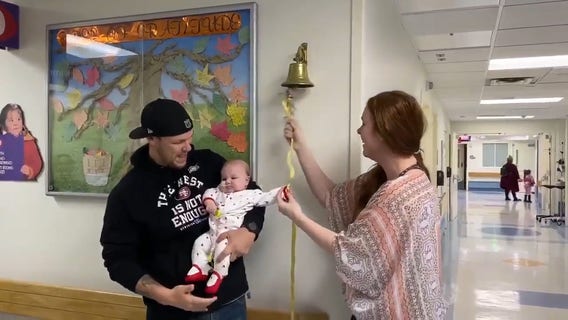 Mom helps infant daughter ring bell after beating brain cancer