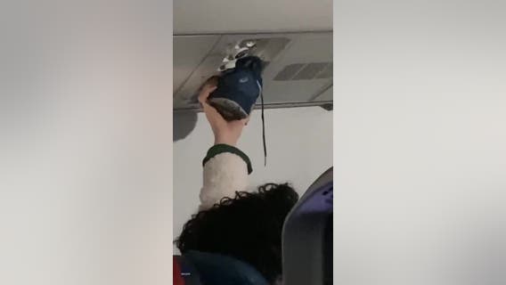 Video: Passengers say nothing as person uses airplane vent to dry shoe