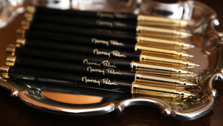 Pens with U.S. Speaker of the House Nancy Pelosi's (D-CA) signature are prepared for the engrossment ceremony of the articles of impeachment against President Donald Trump in the Rayburn Room at the U.S. Capitol