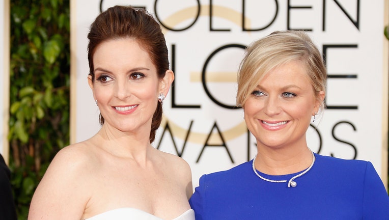 Hosts Tina Fey (L) and Amy Poehler attend the 72nd Annual Golden Globe Awards at The Beverly Hilton Hotel on January 11, 2015 in Beverly Hills, California.
