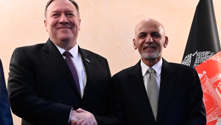US Secretary of State Mike Pompeo (L) shakes hands with Afghan President Ashraf Ghani (R) during the 56th Munich Security Conference (MSC) in Munich, southern Germany, on February 14, 2020. (Photo by ANDREW CABALLERO-REYNOLDS/POOL/AFP via Getty Images)
