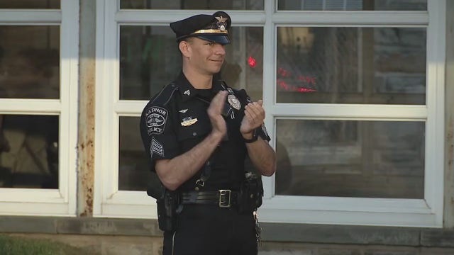 Neighboring police departments applaud Bryn Mawr healthcare providers during shift change