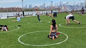 New York City enforcing social distancing with circles on grass, distance signs