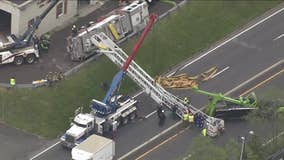 Fire truck displaying American flag overturns onto roadway in Bucks County