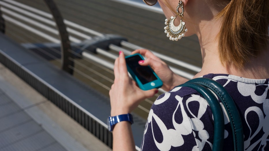 UK - London - Girl using her smartfone