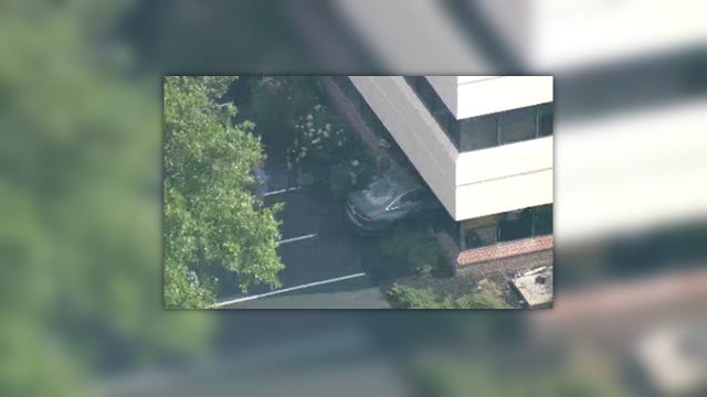 Driver escapes injuries after car crashes into office, officials say
