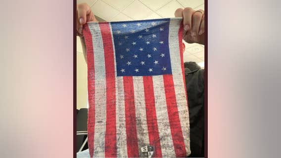 Air marshal says he was asked to remove his American flag face covering