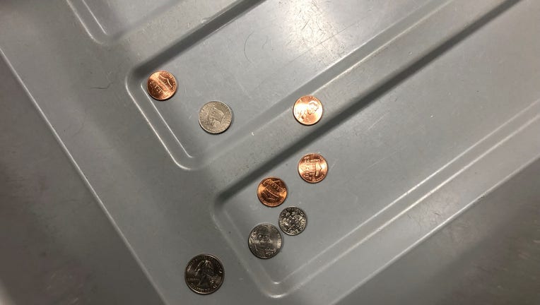 coins in TSA bin