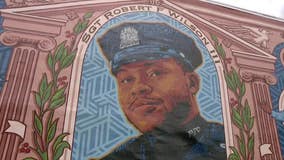 Family, local officials gather to denounce the defacing of Sgt. Wilson mural