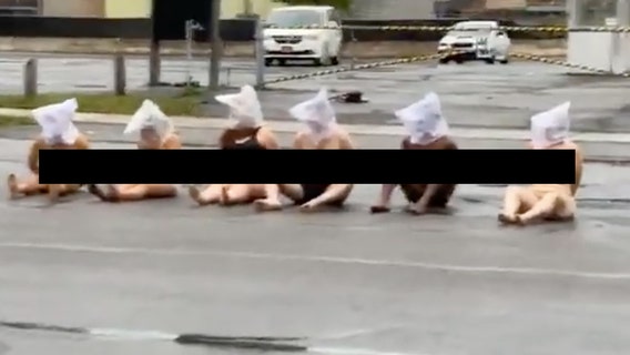Naked protesters wear 'spit hoods' outside Rochester police building