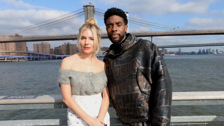 Sienna Miller(L) and Chadwick Boseman poses during a photo call for 