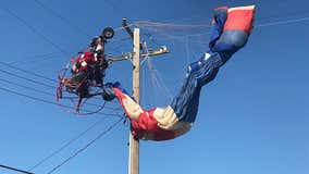 Paraglider dressed as Santa gets tangled in power lines while delivering candy canes