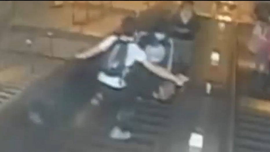 Man kicks woman on escalator