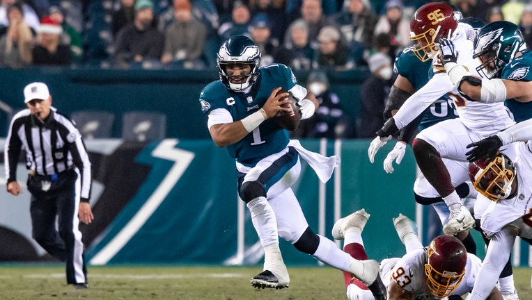 PHILADELPHIA, PA - JANUARY 03: Washington Football Team defensive end  Montez Sweat (90) sacks Philadelphia Eagles quarterback Jalen Hurts (2)  during the game between the Washington Football Team and the Philadelphia  Eagles