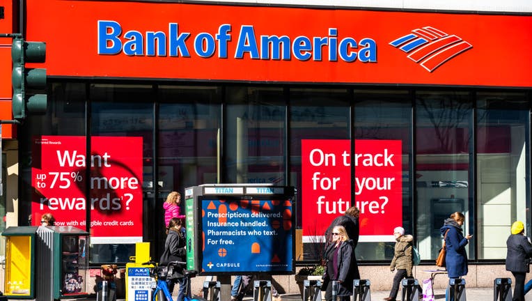 Pedestrians walk past a branch of Bank of America in New