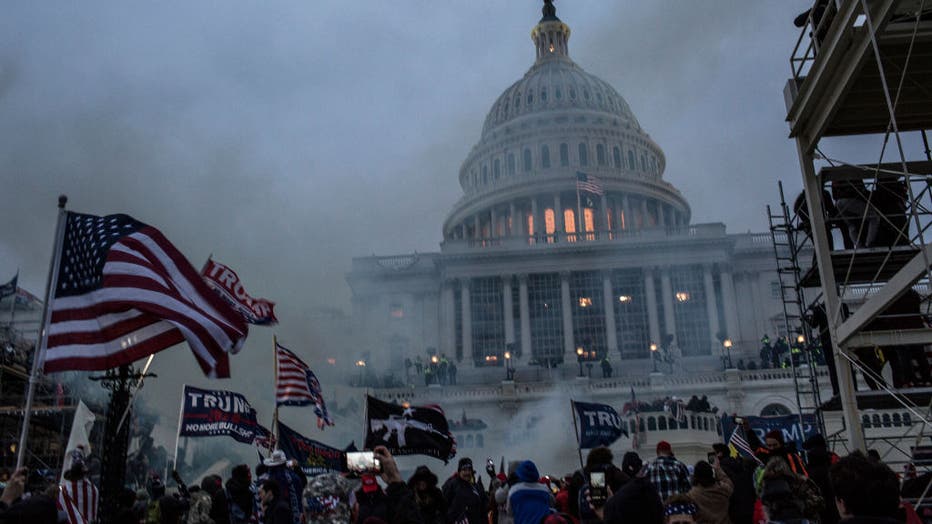 0ebfe3e6-Security forces respond with tear gas after the US President