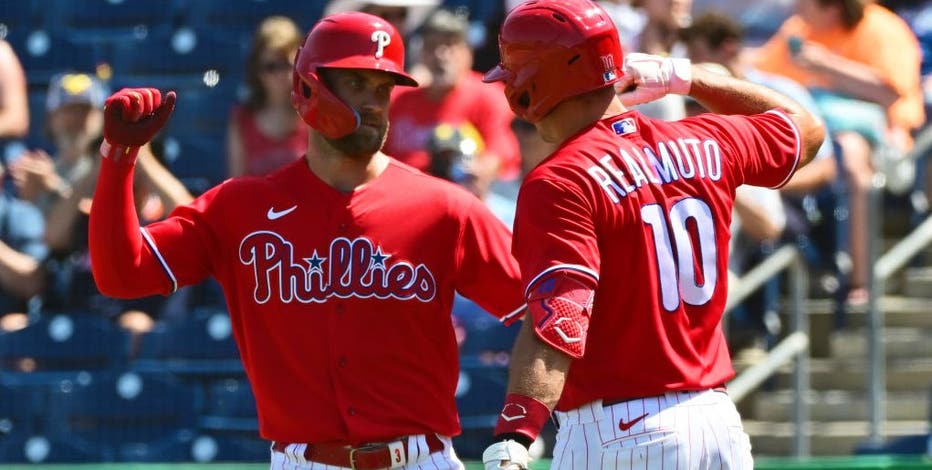 Philadelphia Phillies' Didi Gregorius, left, and Zack Wheeler put