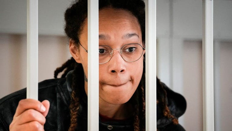 Brittney Griner holds picture at Russian court hearing of WNBA All