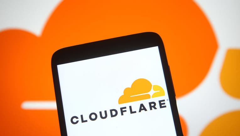 In this photo illustration, the US Cloudflare logo