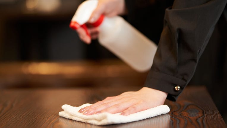 Hands of a female clerk who disinfects alcohol