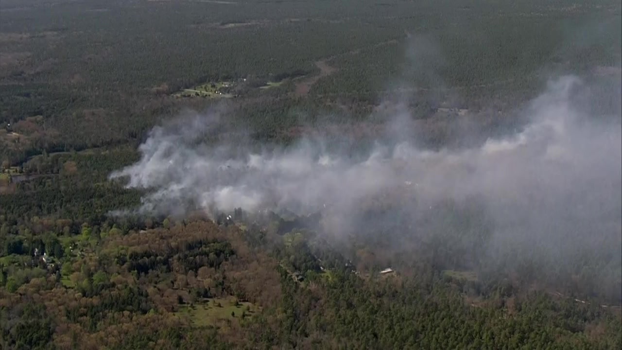 Over two dozen structures threatened by uncontained wildfire in Washington Township