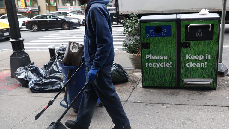 Worker-cleans-sidewalk.jpg