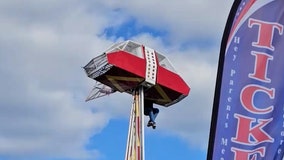Dramatic video shows carnival worker clinging to ride to protect child after mishap