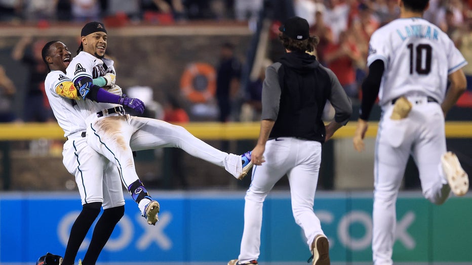 Ketel Marte of the Arizona Diamondbacks reacts after being hit by a News  Photo - Getty Images