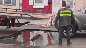 Large sinkhole claims vehicles, while some attempt a swim in Port Richmond