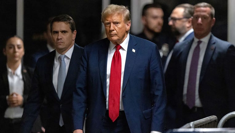 Former US President Donald Trump, center, and Todd Blanche, attorney for former US President Donald Trump, second left, at Manhattan criminal court in New York, on April 25, 2024. Photographer: Jeenah Moon/Bloomberg via Getty Images