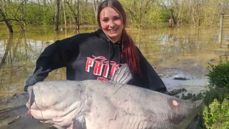 101 pound blue catfish being held by girl